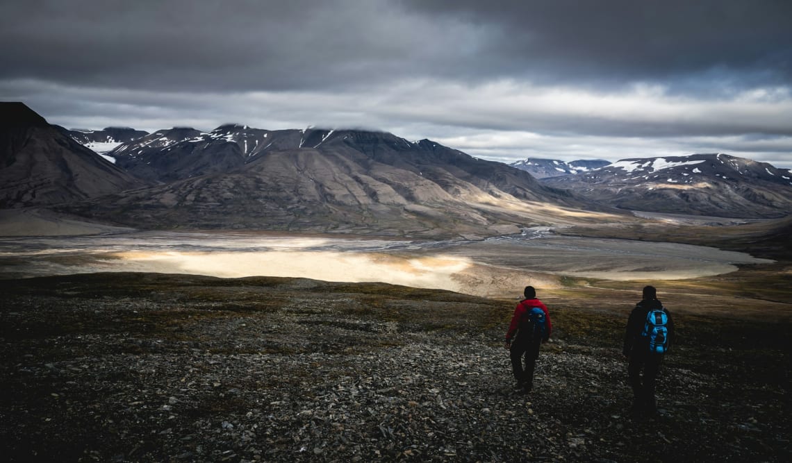 Two people on a hiking excursion in Svalbard