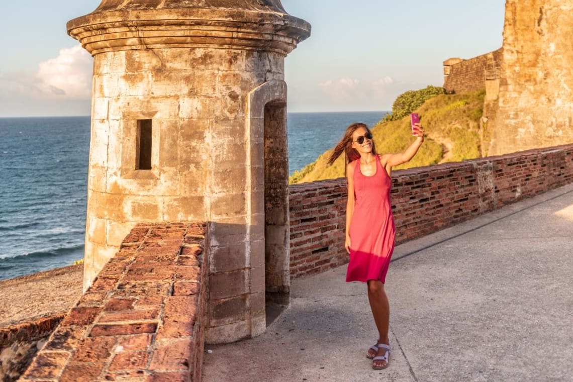 Girl taking a selfie in a historical landmark in Puerto Rico