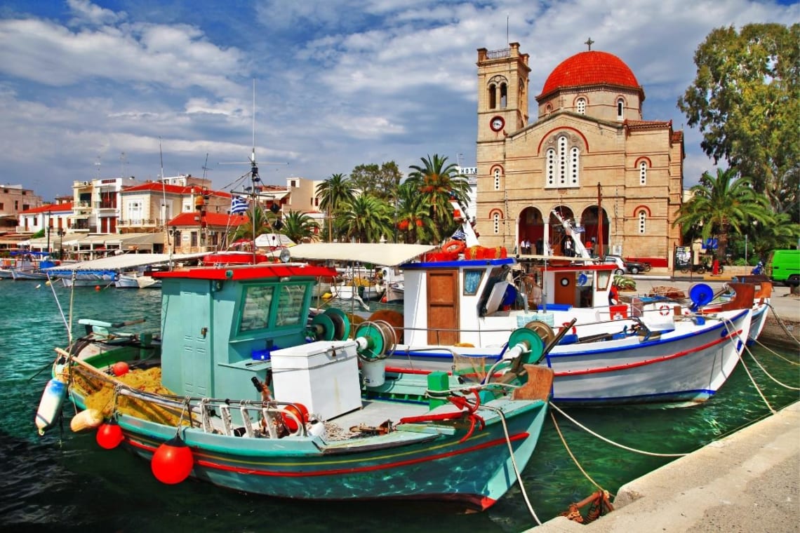 Two boats docked in colorful Aegina island, Greece