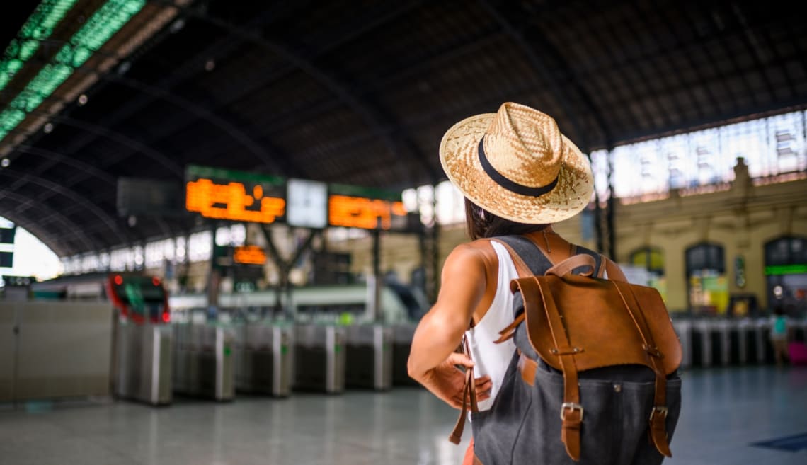 Girl with a backpack at a train station 