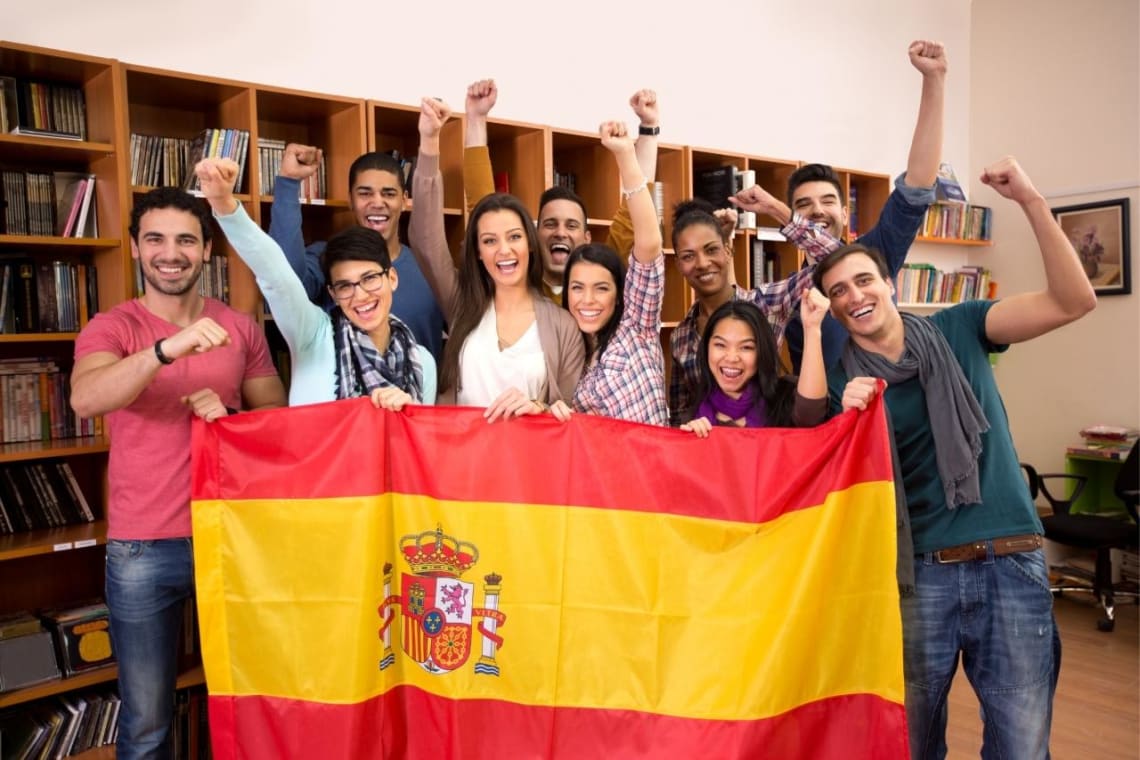 Group of  students holding a Spanish flag