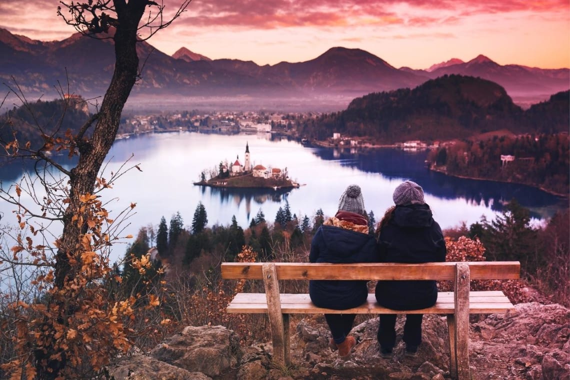 Couple in a bench looking at Bled Lake
