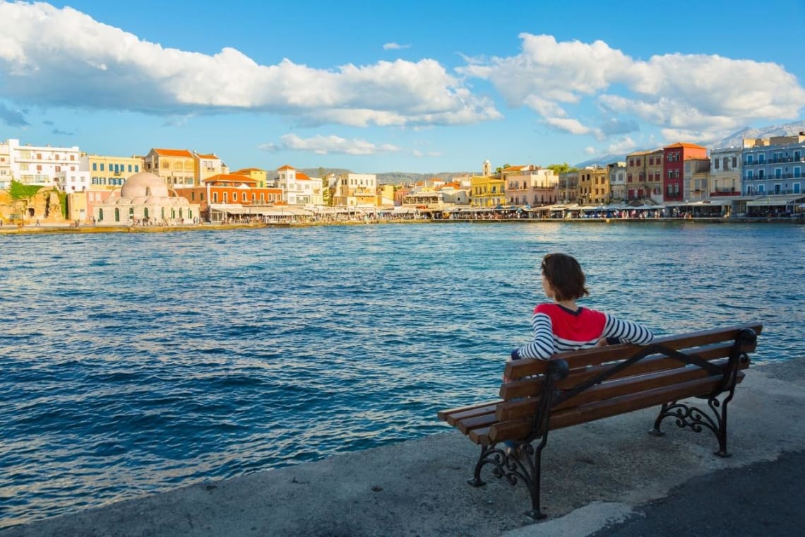 Girl sitted on a bench in Crete island, Greece