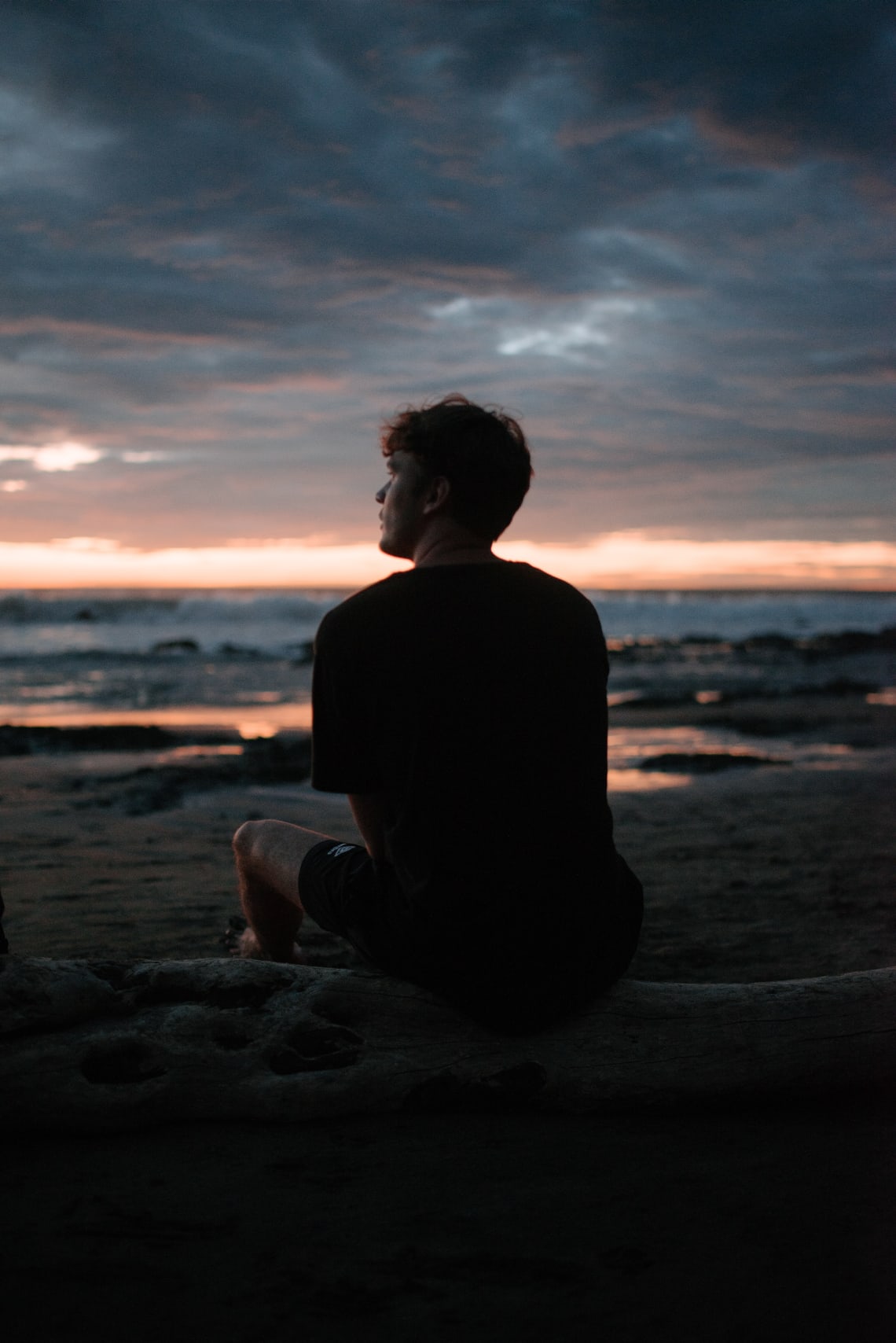 Solo traveler enjoying an ocean sunset