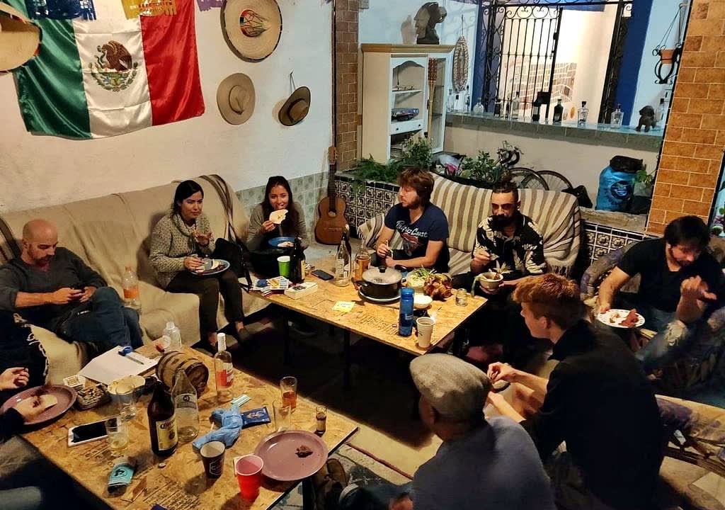 Common area of a hostel in MExico with many guests eating