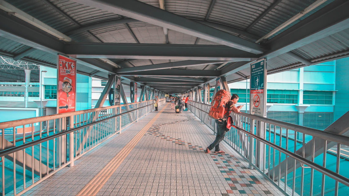 backpacker planning his travel using a mobile app