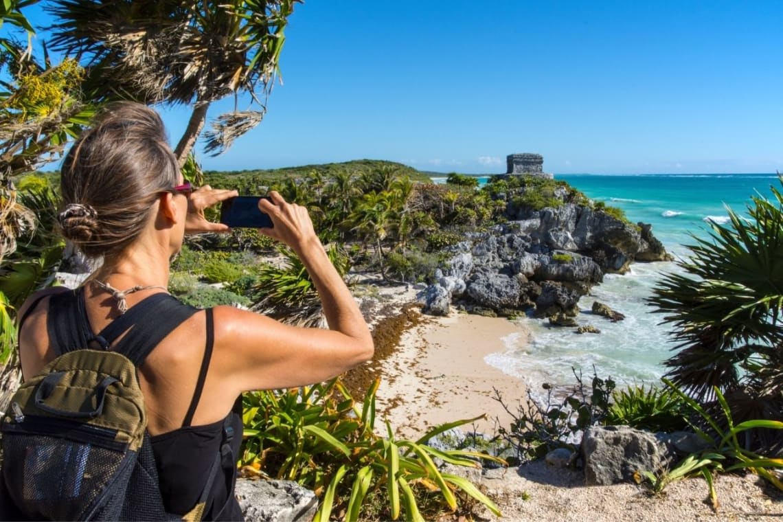 Woman backpacking Mexico taking a picture in Tulum