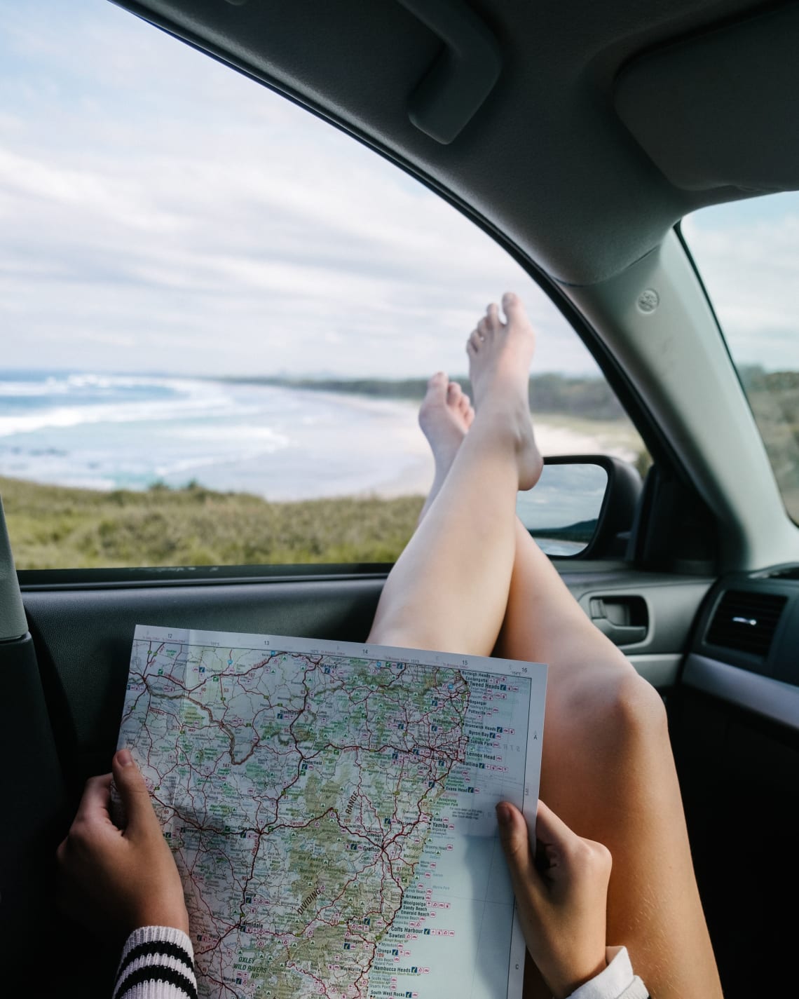 Solo female traveler using a map to make travel plans