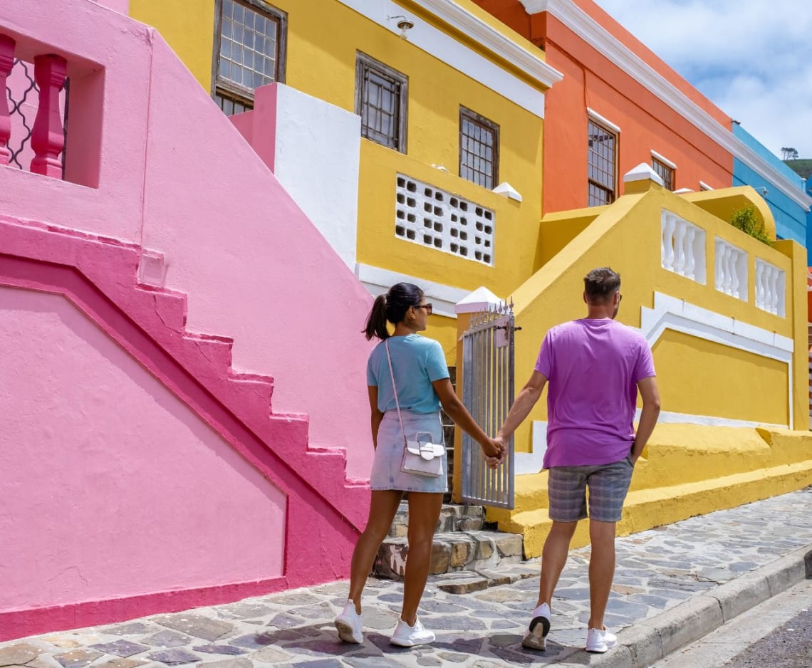 Couple walking next to colorful houses