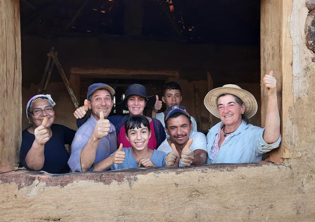 Members of an off-the-grid community thumbs up for a picture