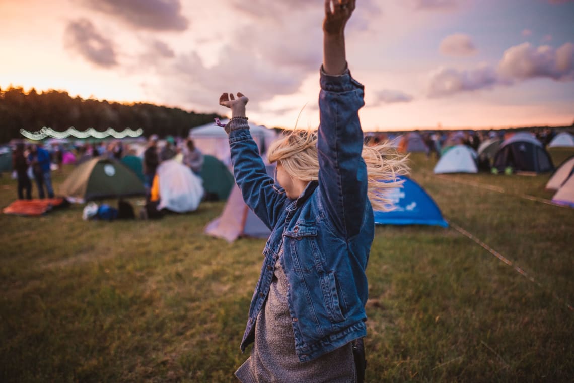 Solo female traveler at an outdoor camping festival