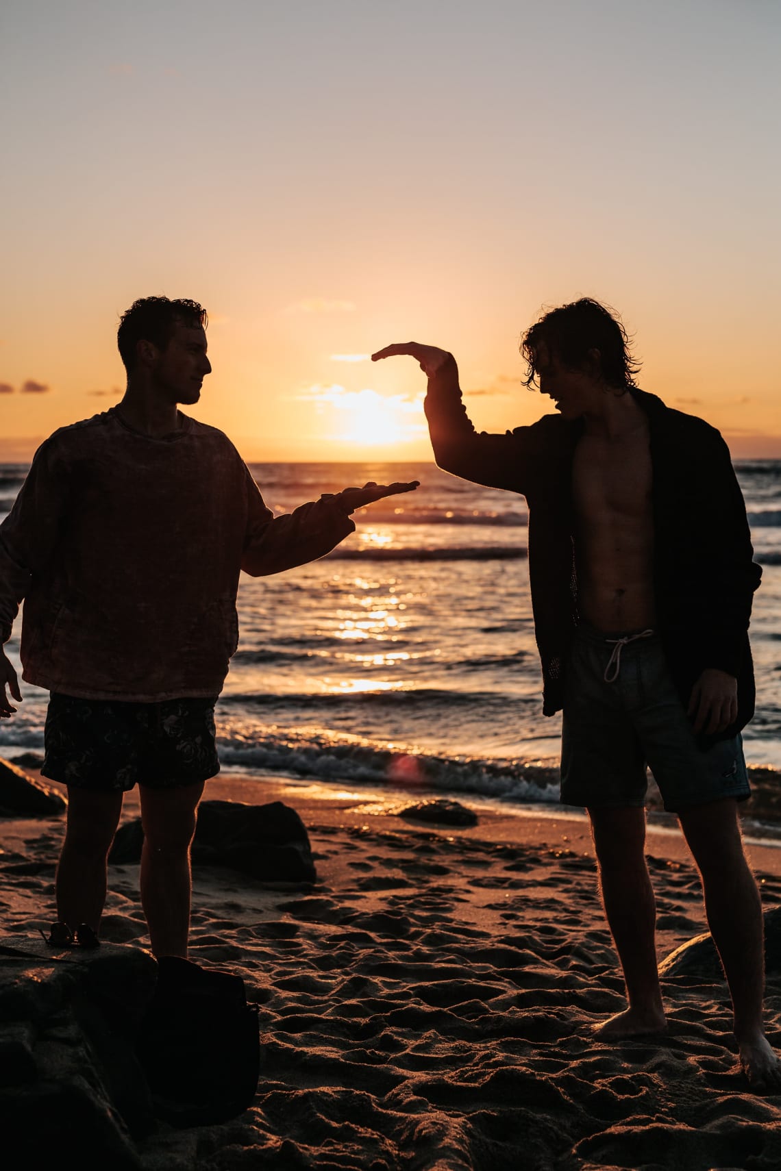 Two friends enjoying a beach sunset