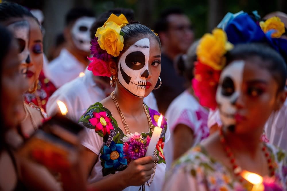 Girl with a candle in traditional "Dia de muertos" celebration