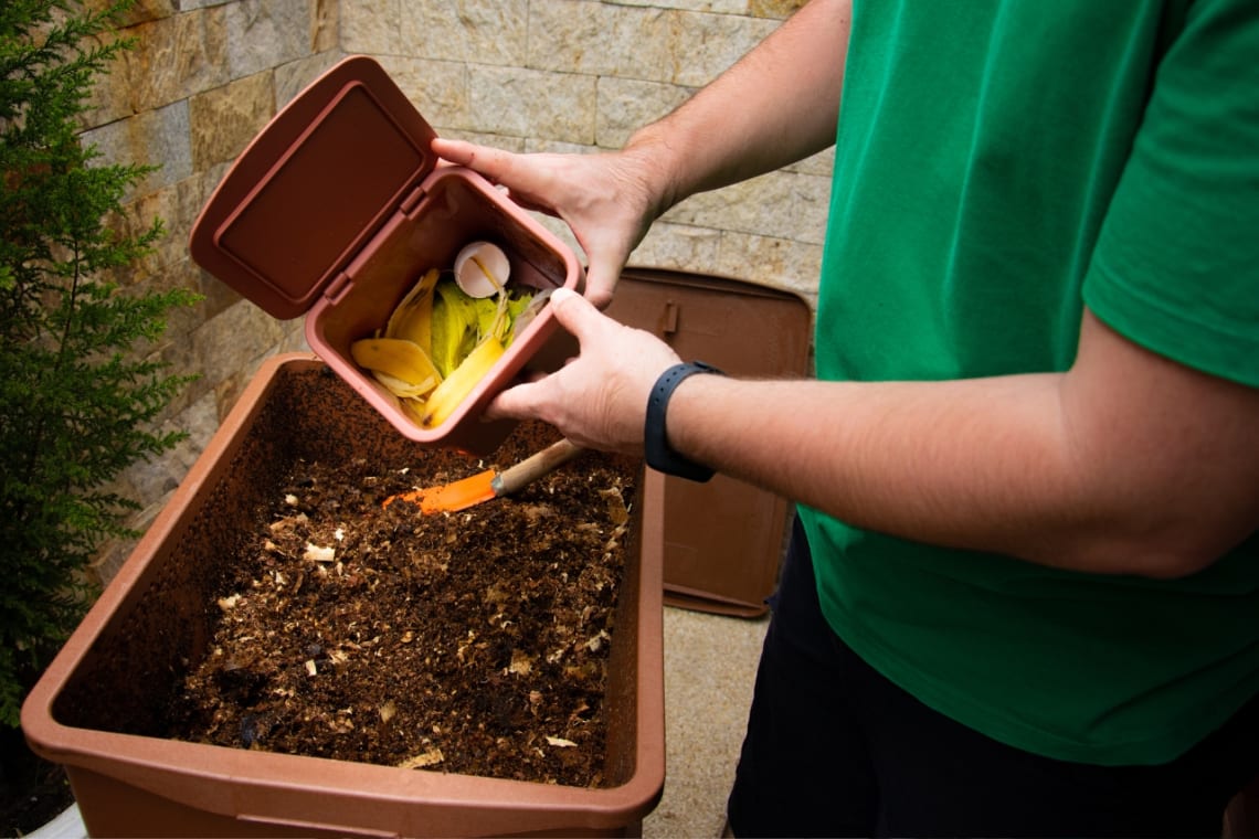Guy composting organic scraps