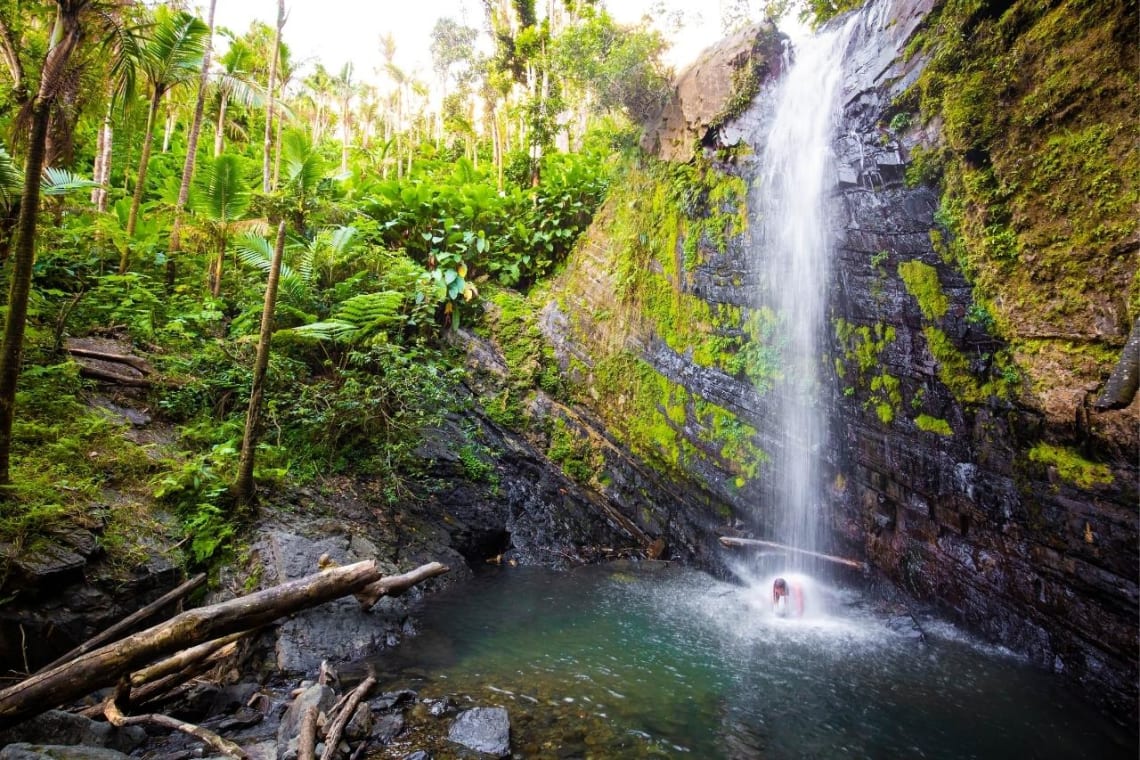 Girl having a bath in a waterfall in Puerto Rico