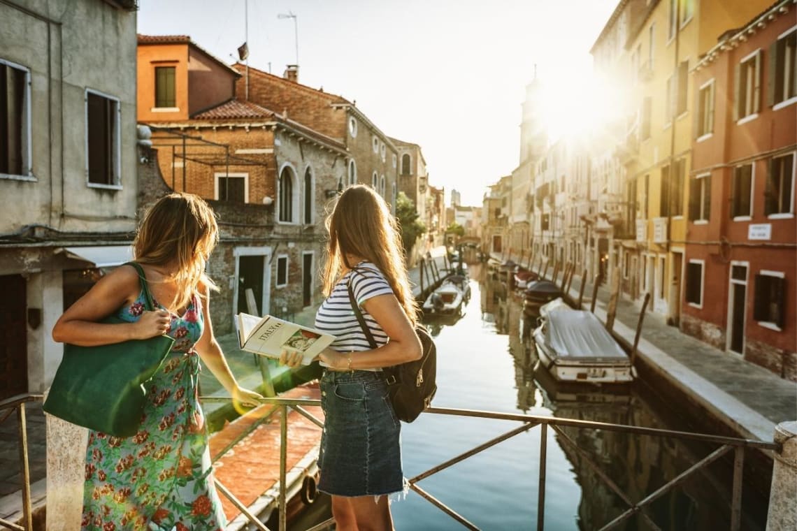 Two girls looking at a canal in Venice