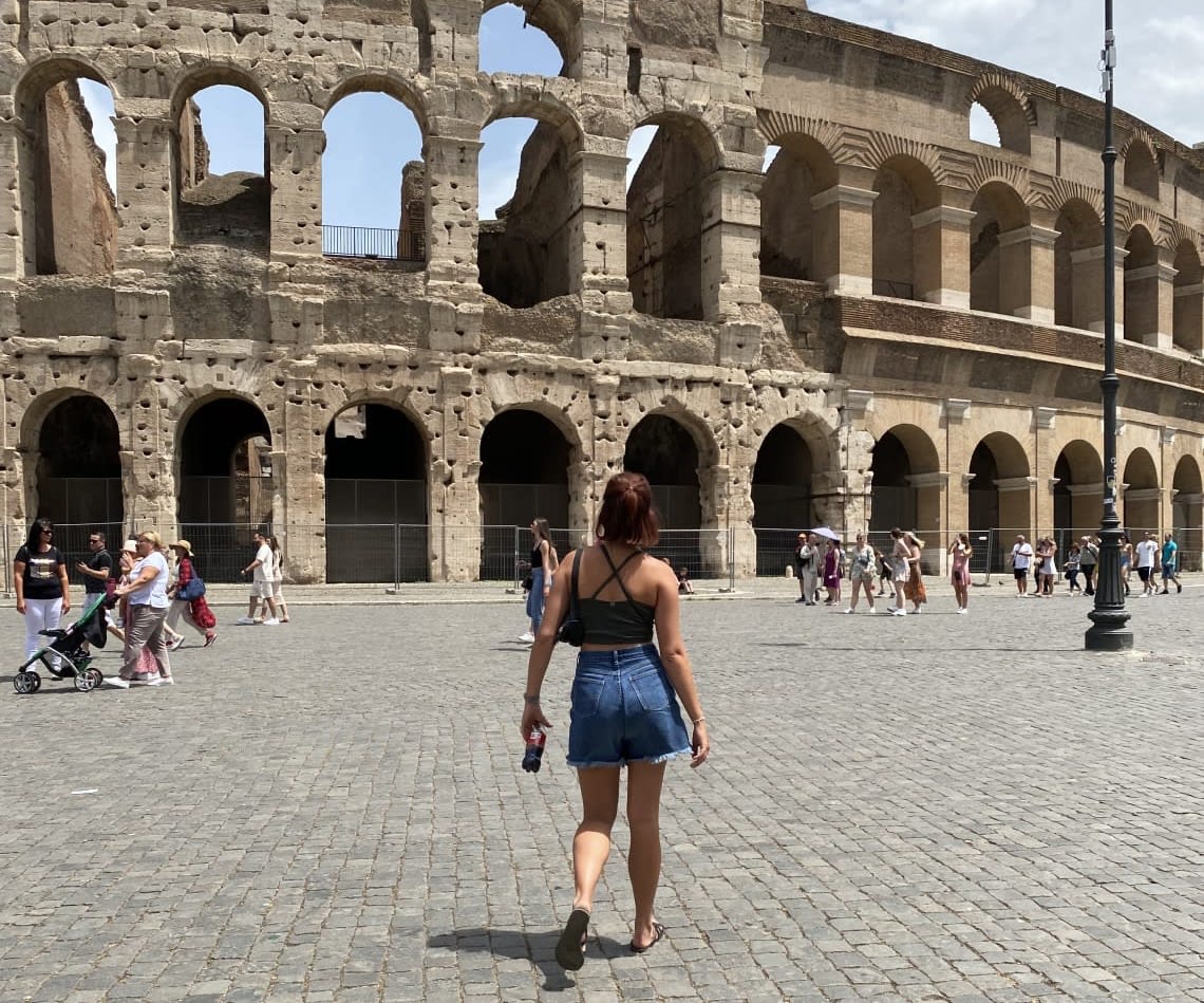 Walking in front of the Colisseum