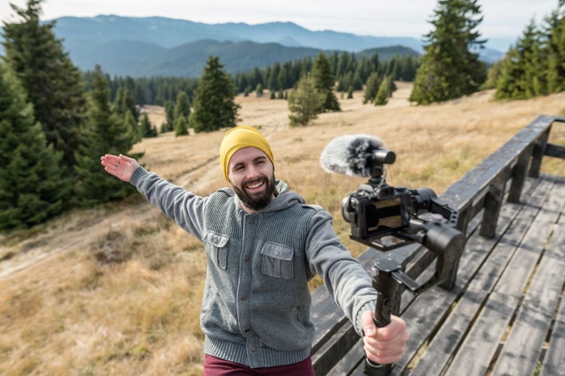 Travel influencer filming himself in a natural environment