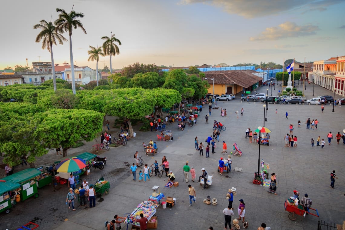 Is Nicaragua safe? People strolling and street vendors in a city square 