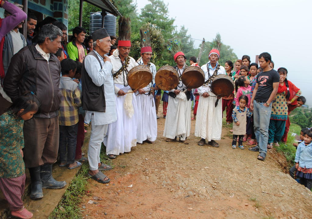 Group of locals playing drums during a traditional ritual in a mountain village in Nepal