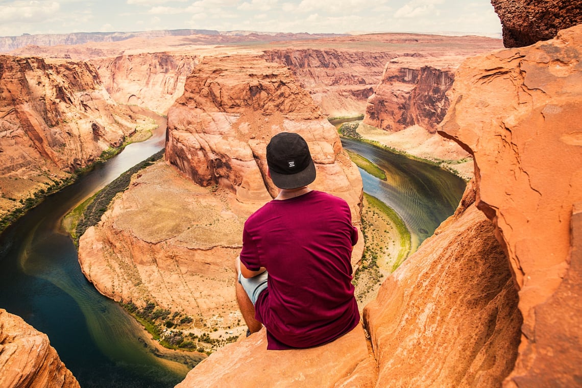 Hiker enjoying the vista, Horseshoe Bend, Arizona