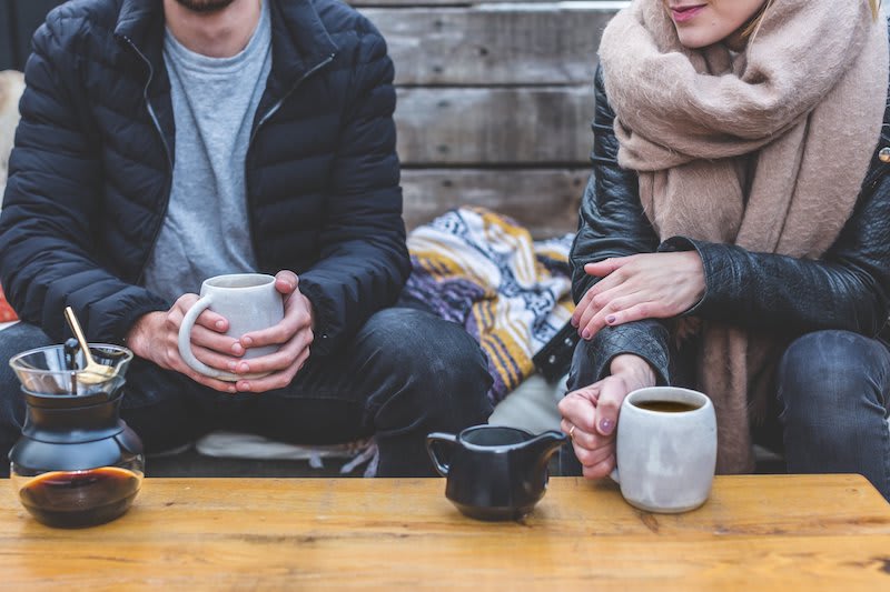 Friends discussing travel plans over coffee