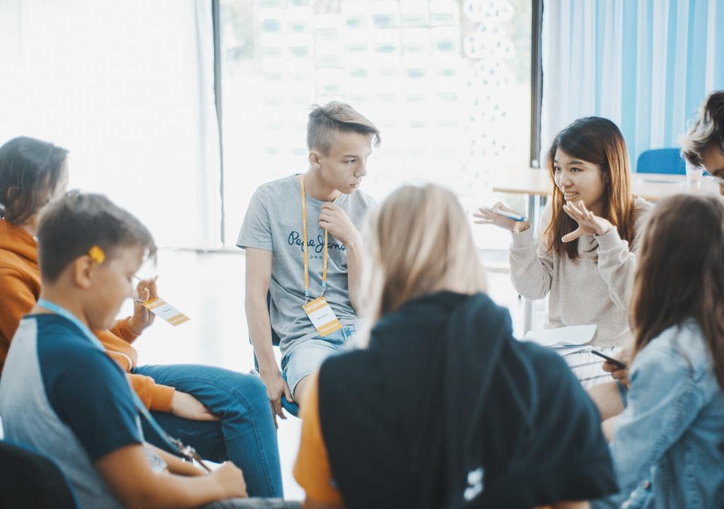 Young girl teaching English in Portugal to teenager students