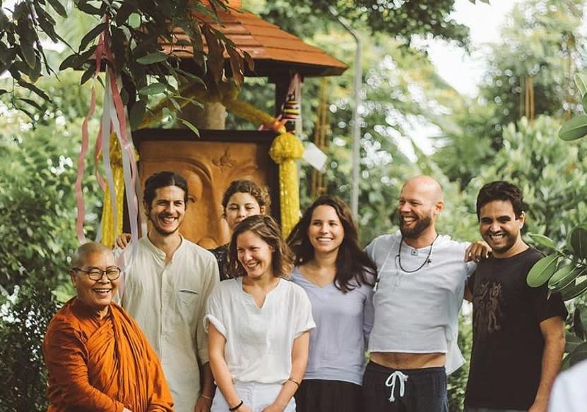 Volunteers from a spiritual retreat with a Buddhist monk