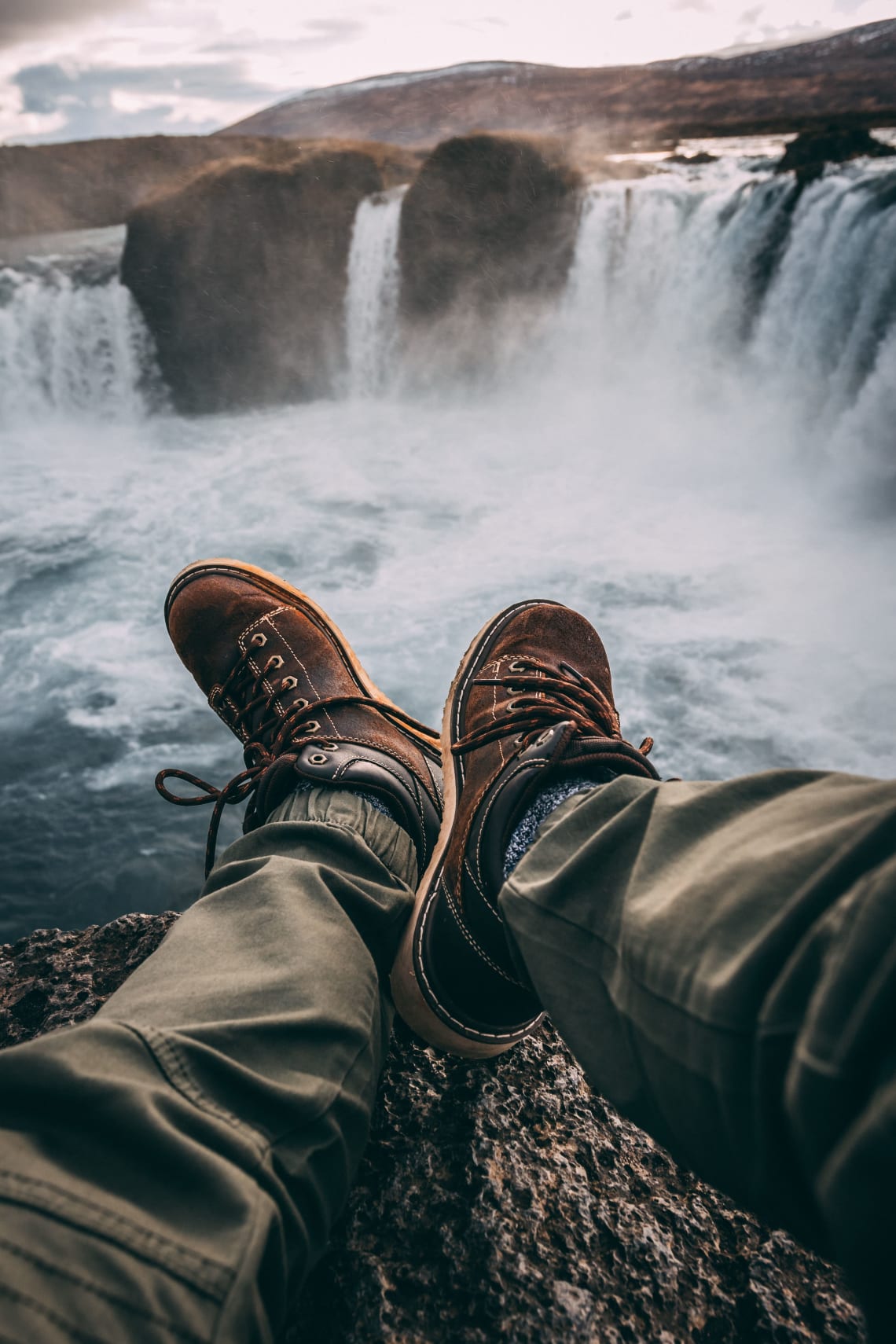 Hiker enjoying a rest stop with waterfall views