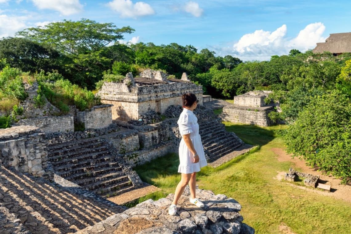 Girl looking at historic ruins in Mexico