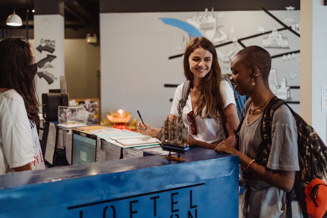 Two girls checking in at a hostel in Europe