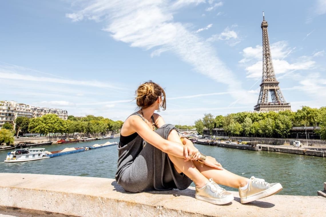 Girl in a gap year looking at the Eiffel Tower