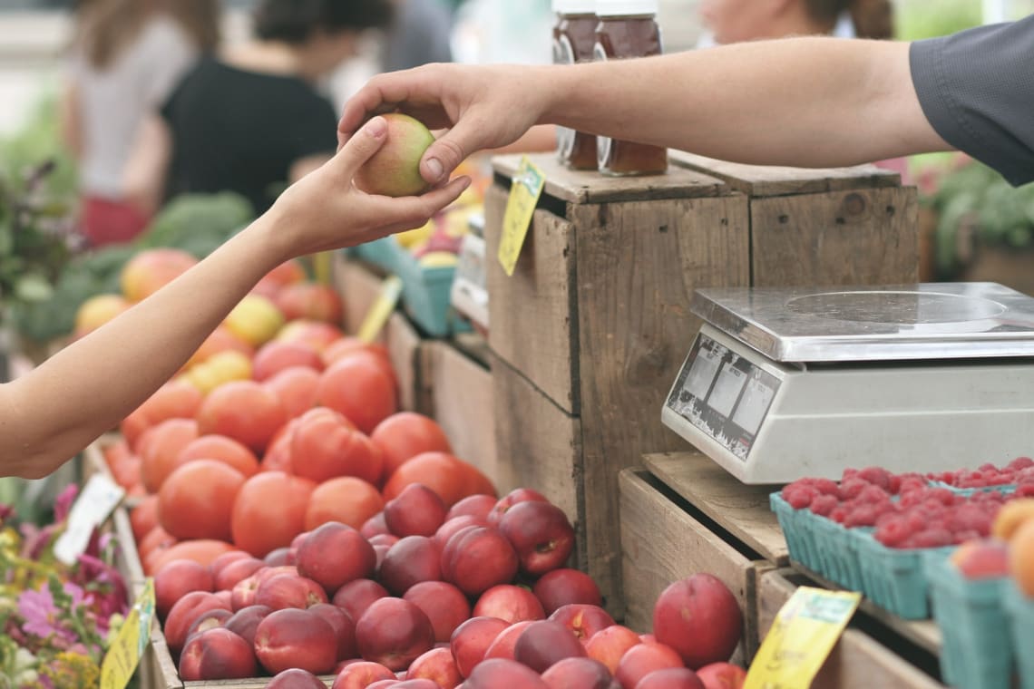 Purchasing fruit at a local market