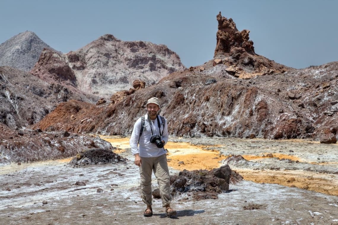 Male traveler walking in a arid area