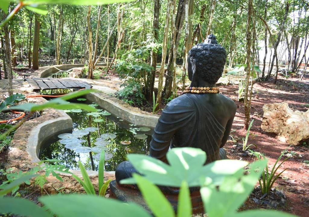 Statue of seating Buddha in a peaceful garden