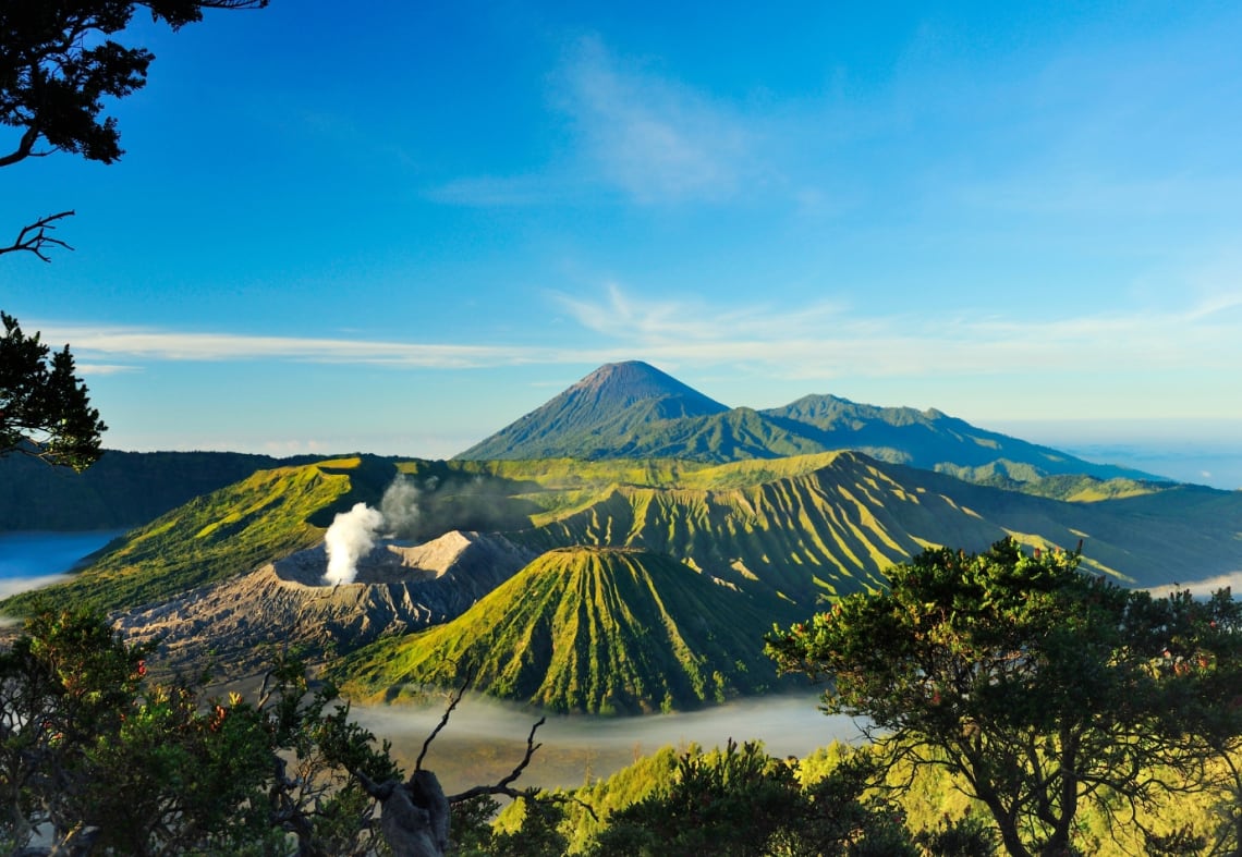 Bromo and Seremu volcanoes viewed from the distance. Climbing this volcano is one of the best things to do in Indonesia