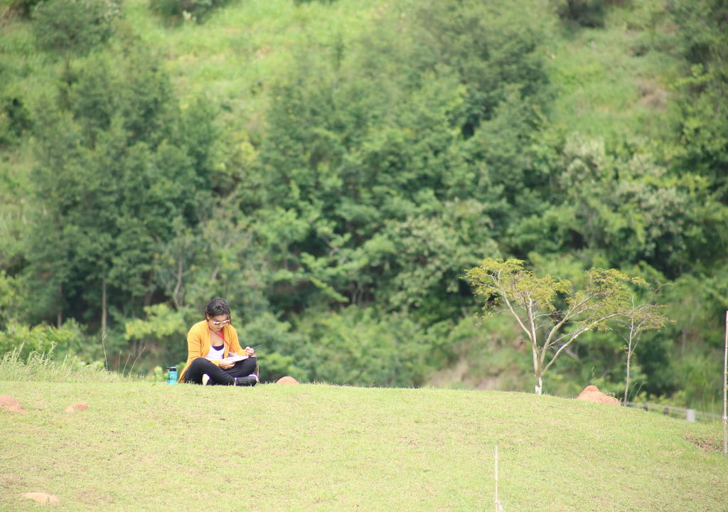 a woman writes in her journal during a retreat