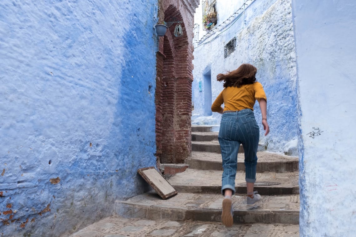 girl running upstairs by herself