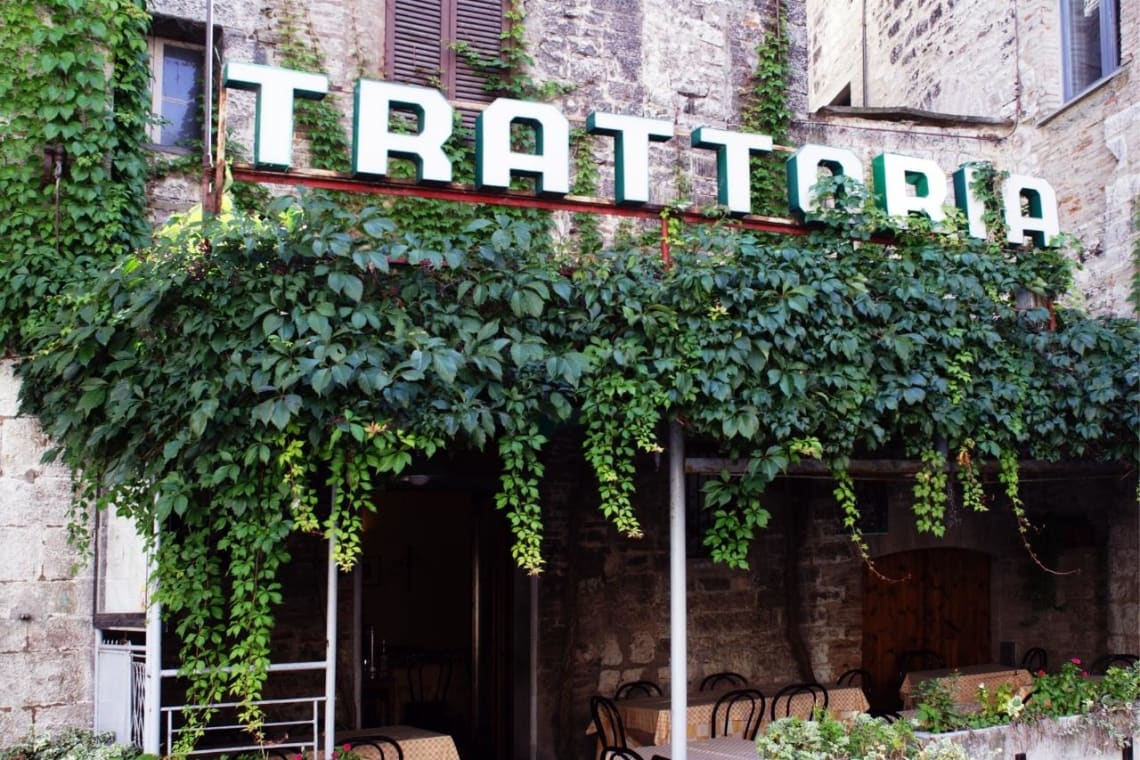 Entrance to a leafy trattoria