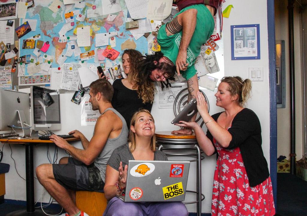 Group of digital nomads working with their computers at a hostel