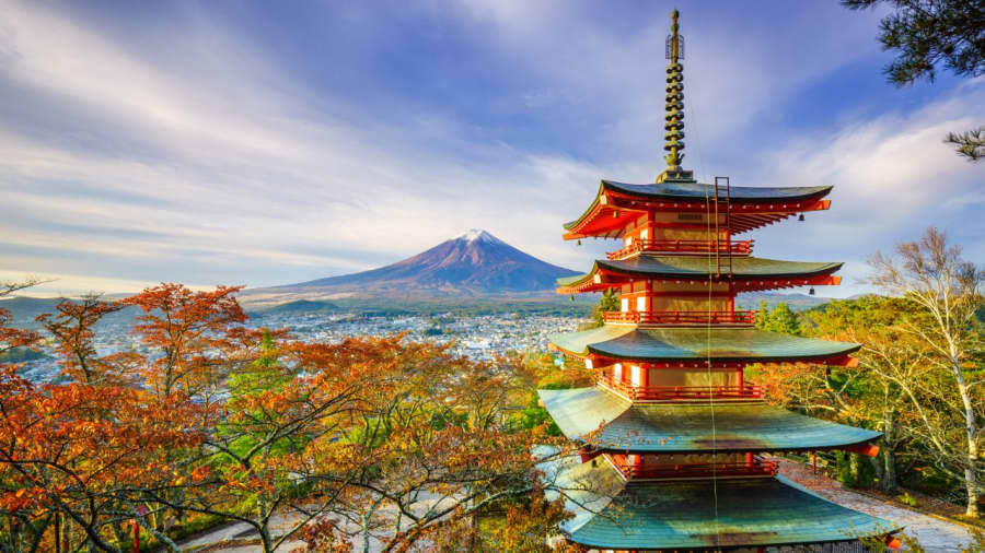 A red pagoda among autumn trees in Japan