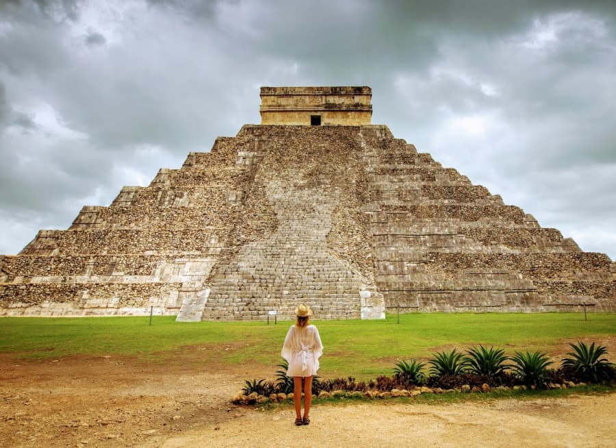A traveller before the pyramid of Chichen Itza, Mexico