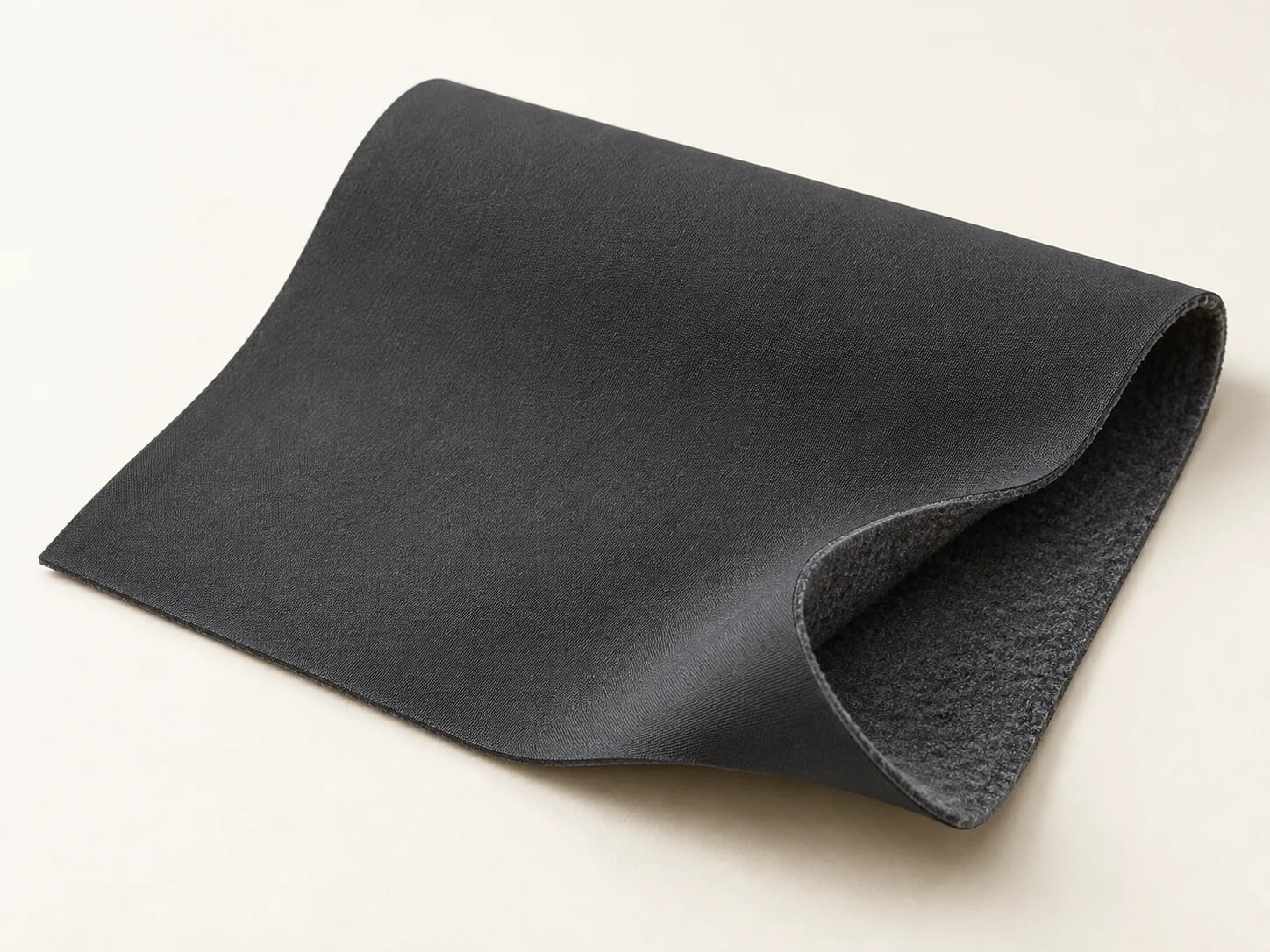 Illustrative charcoal soft-shell fabric, folded shell and lining view