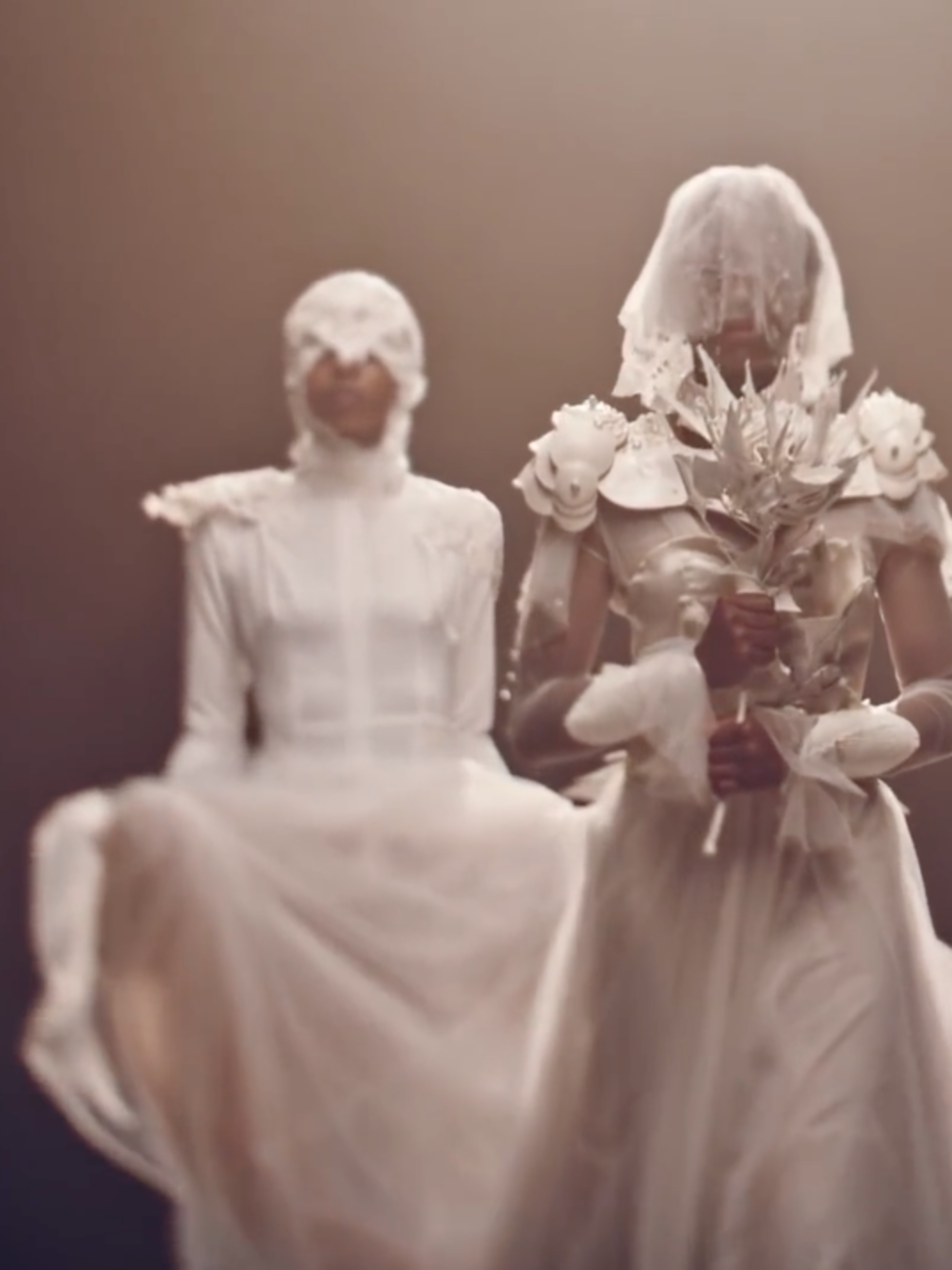 A bride with an armoured dress on flanked by two bridesmaids
