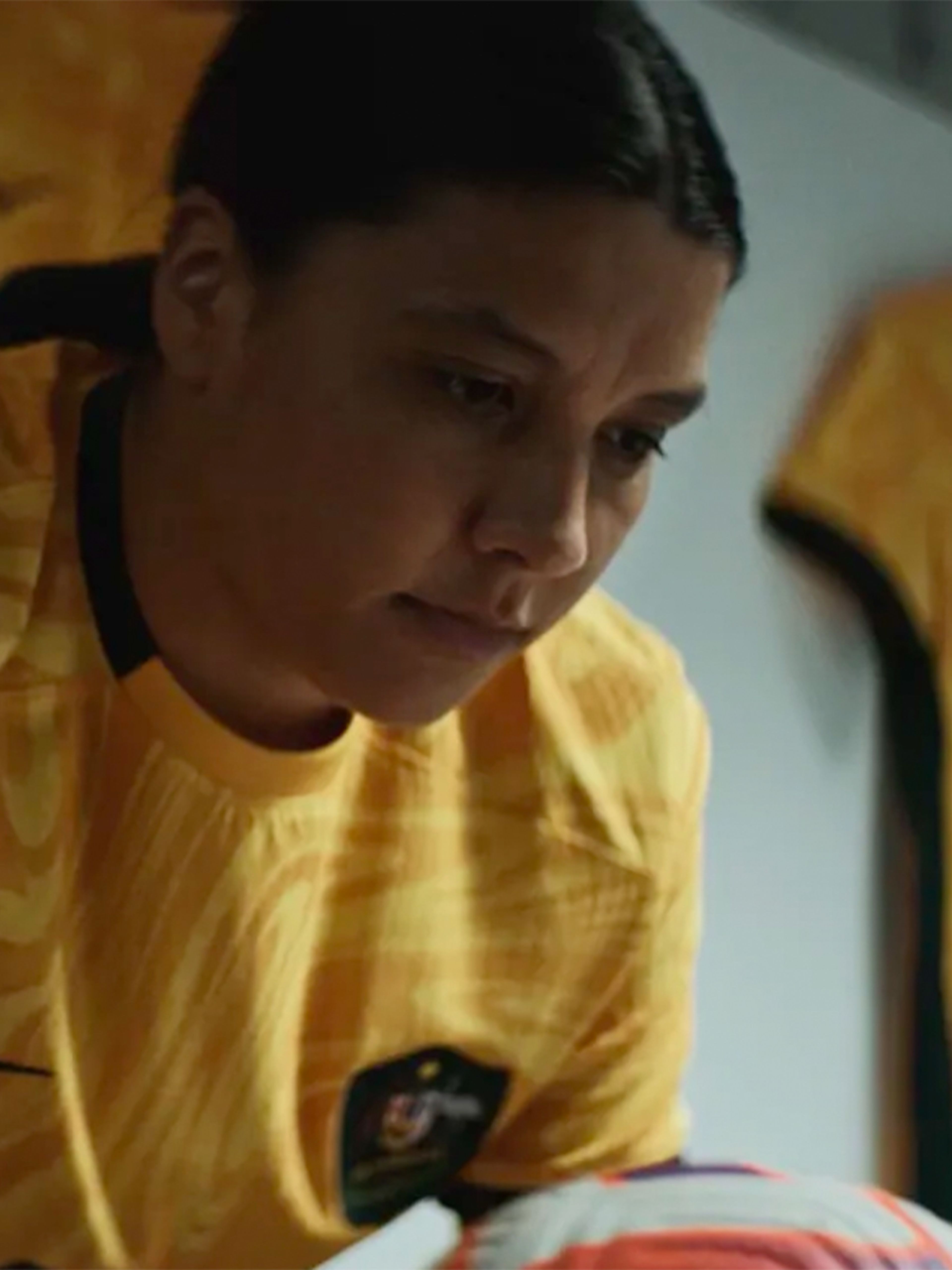 Australian female football player holding ball