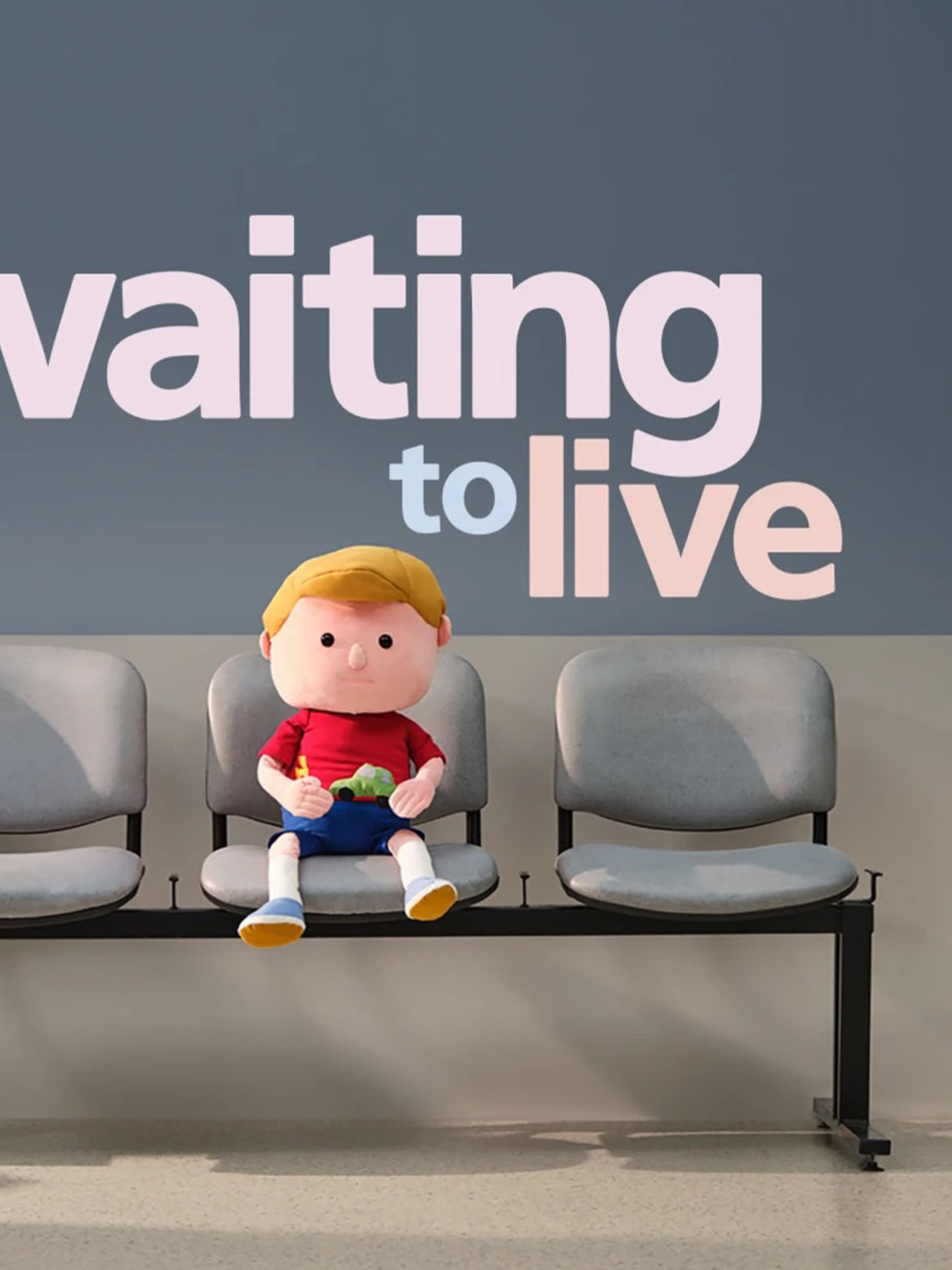Doll of a young boy sitting in a hospital waiting room with the text "Waiting to live"