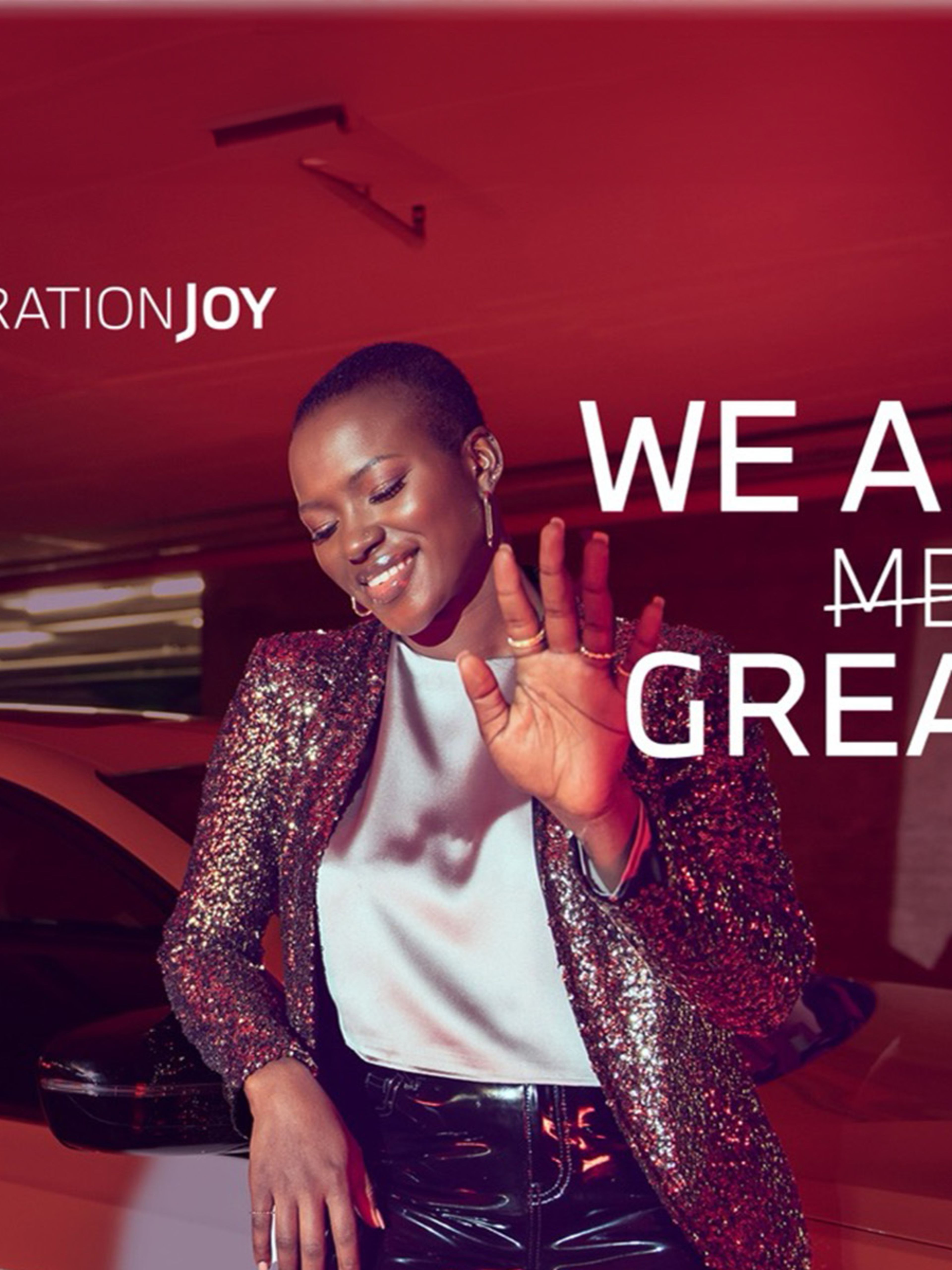 Woman stood in front of a BMW with her hand stretched out in front of her and the text "WE ARE GREATNESS"