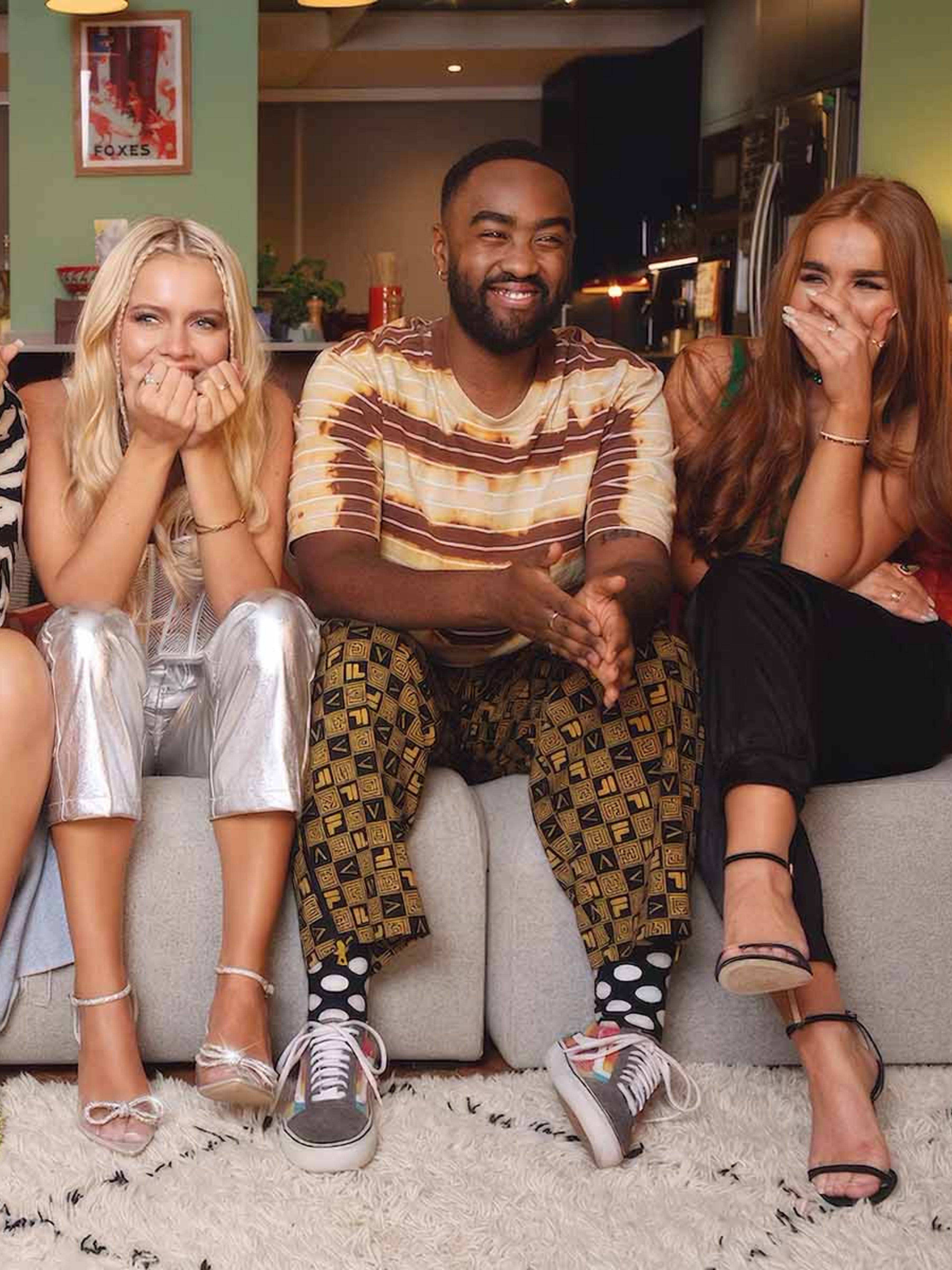 Four people sitting on a sofa wearing clothes from e-Bay