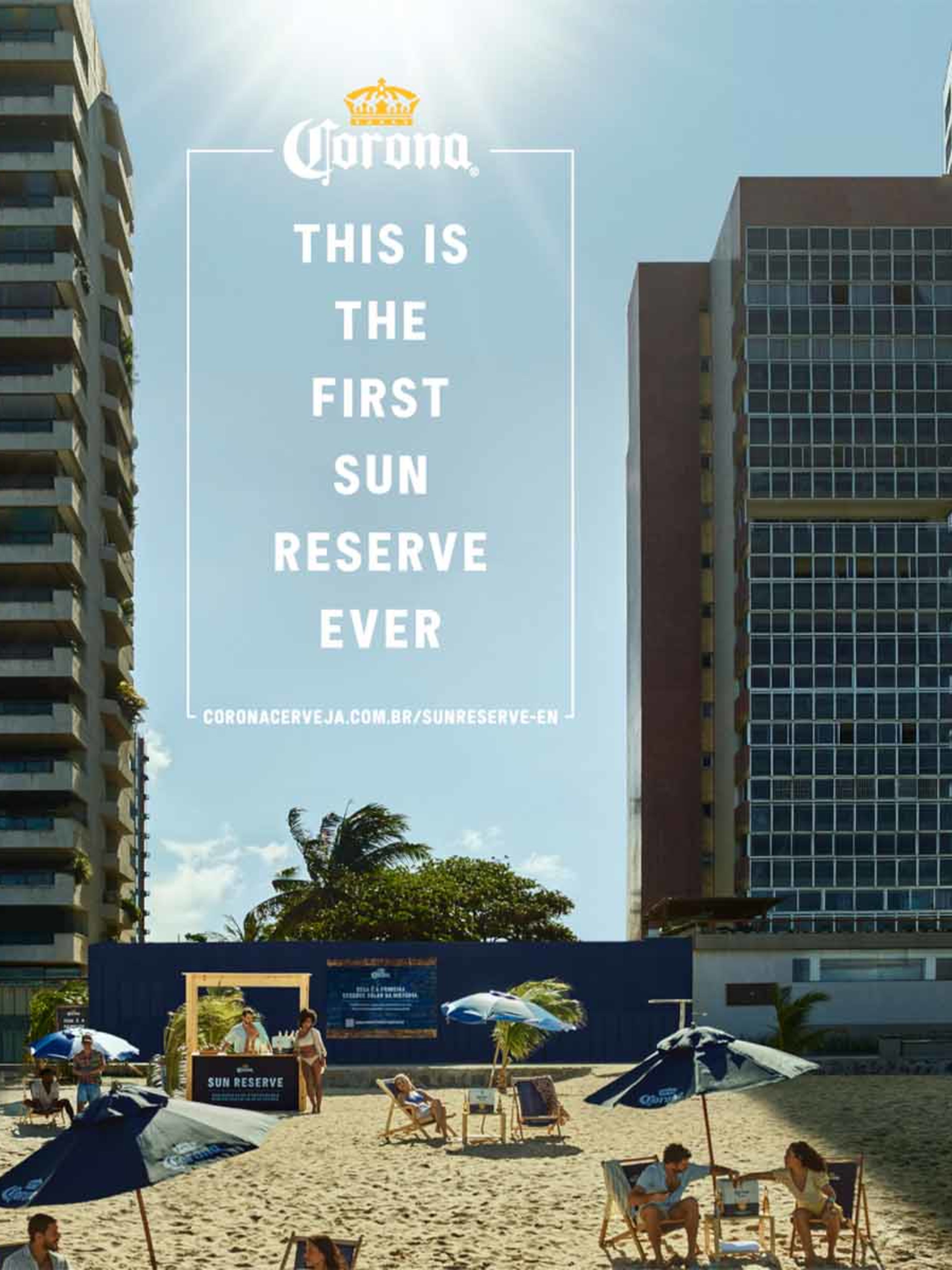 A Corona advertisement showing people relaxing on a beach between tall city buildings.