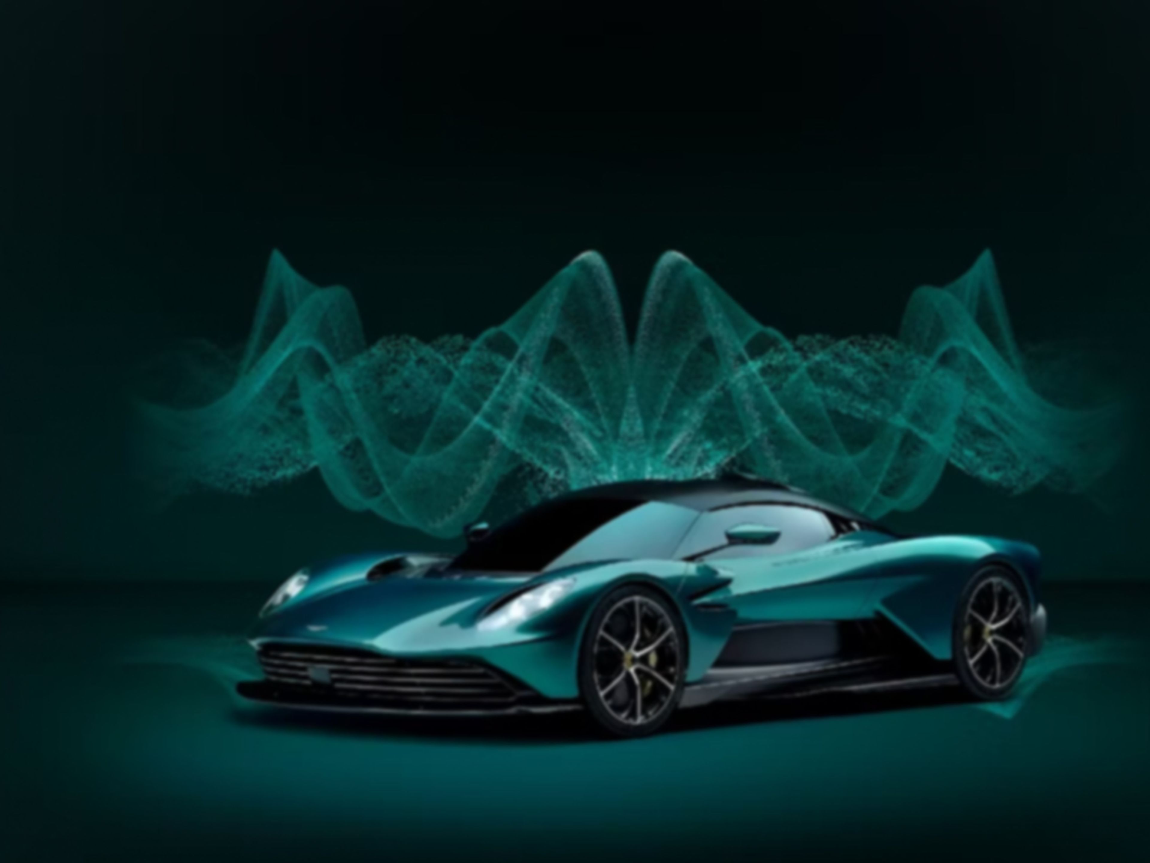 Green Aston Martin Valkyirie car on a green background with glowing green and pulsating visualisations in the background